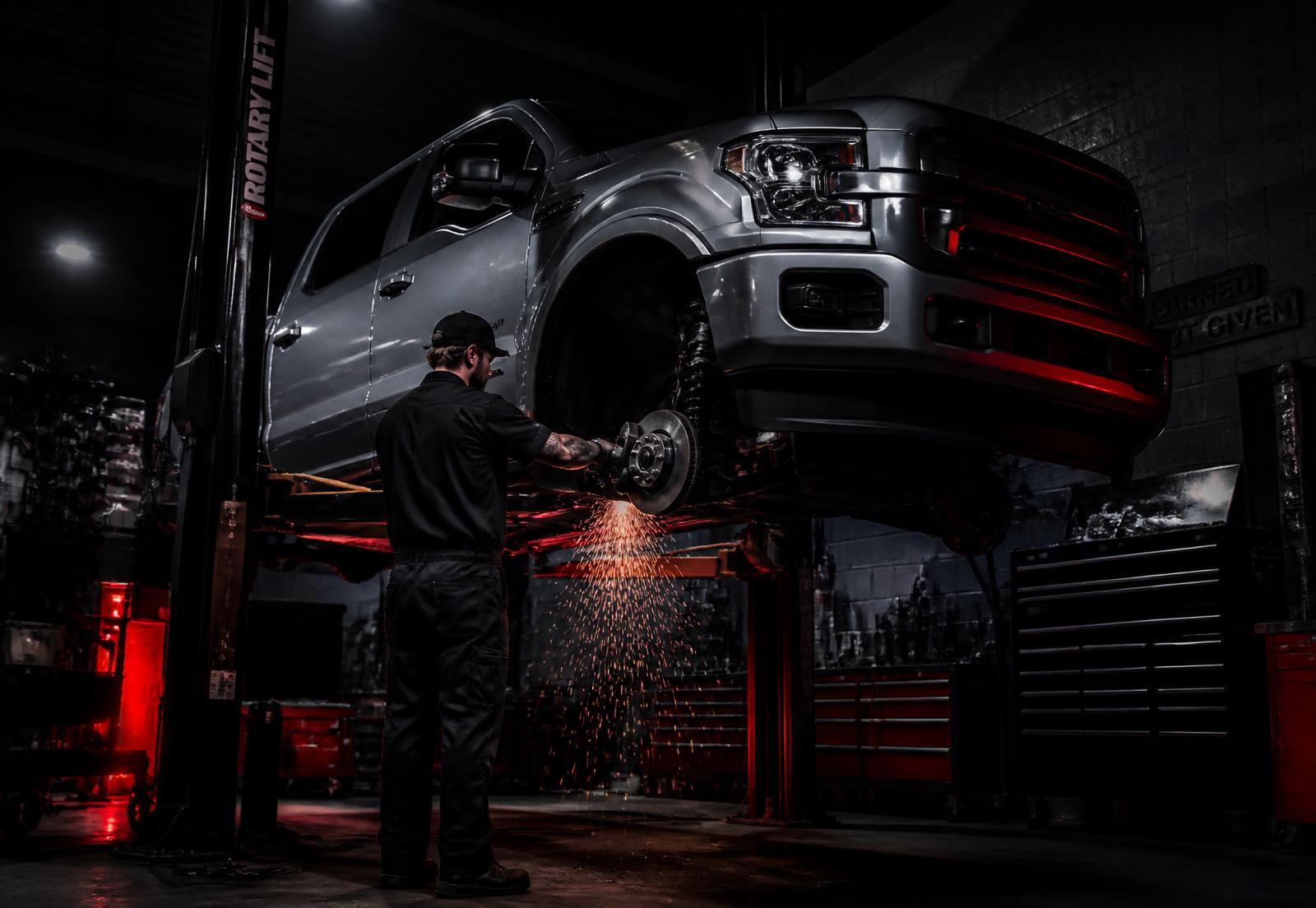 Mechanic servicing a pickup truck on a lift at the Invincible Motors workshop in Montana, Pretoria